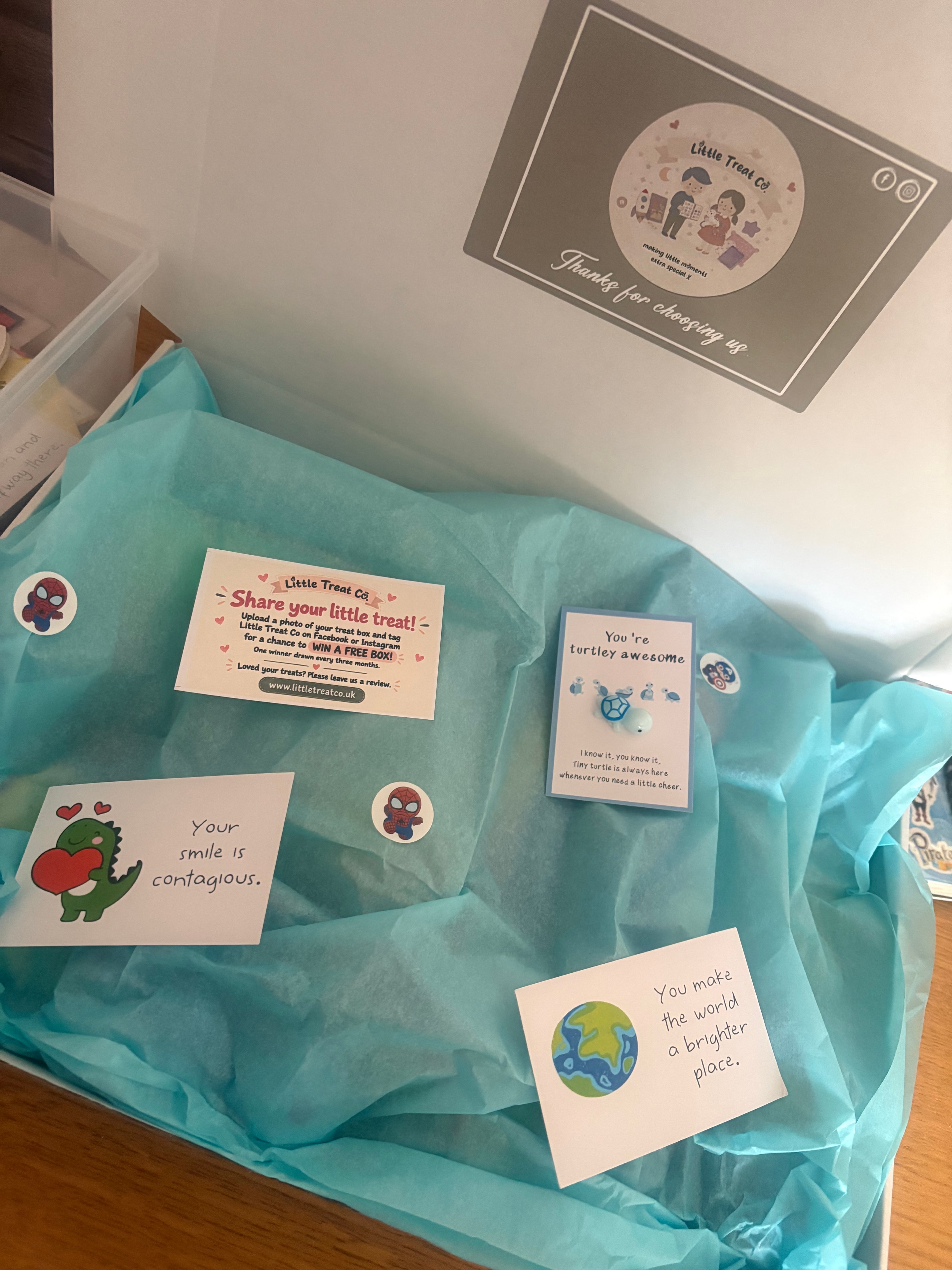 Large deluxe mystery box contents spread out showing Avengers sticker pad, Spider-Man colouring set, gliders, fidget toys and sweet treats