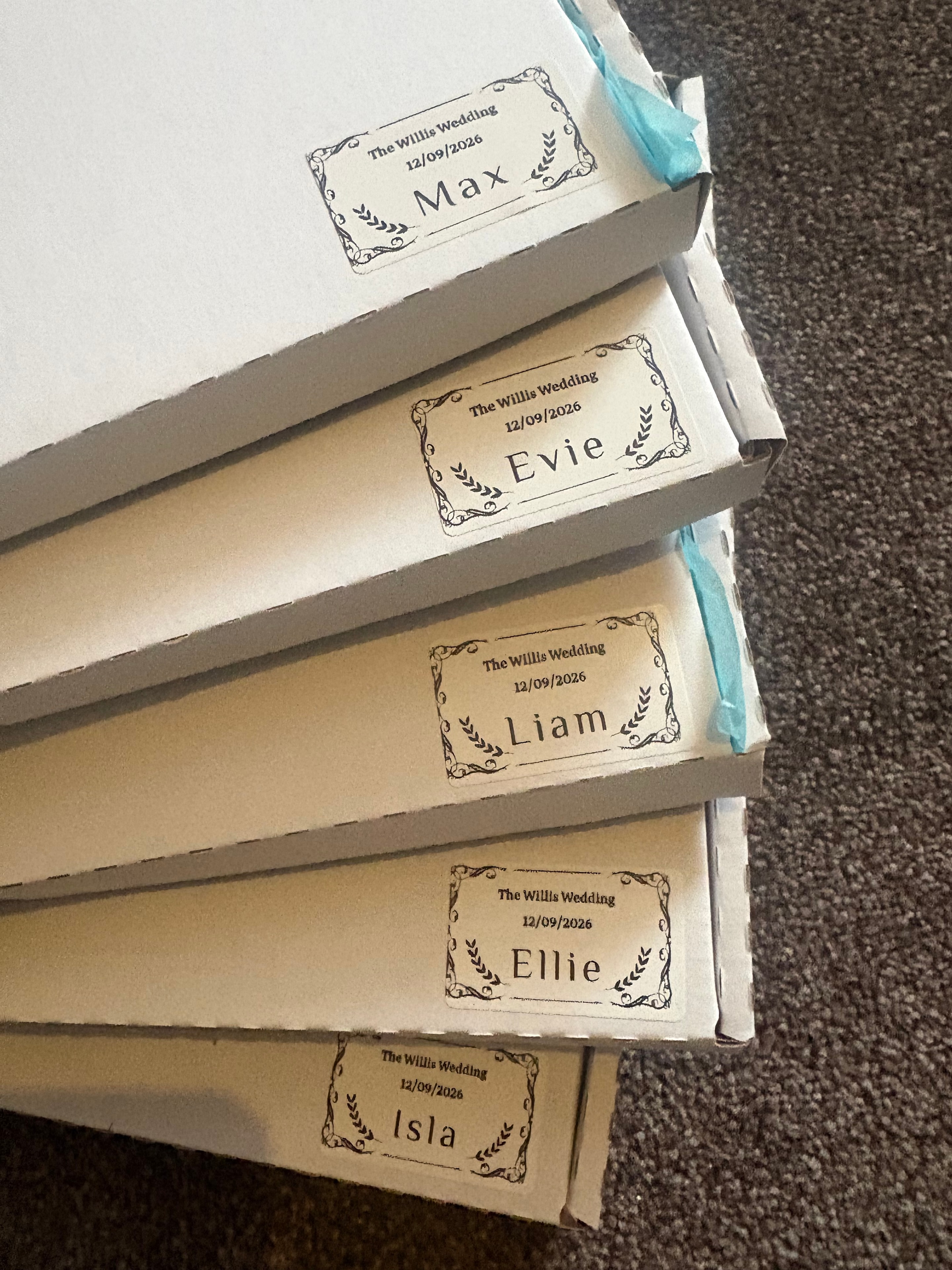 Personalised wedding activity packs for children labelled with individual names and wedding date